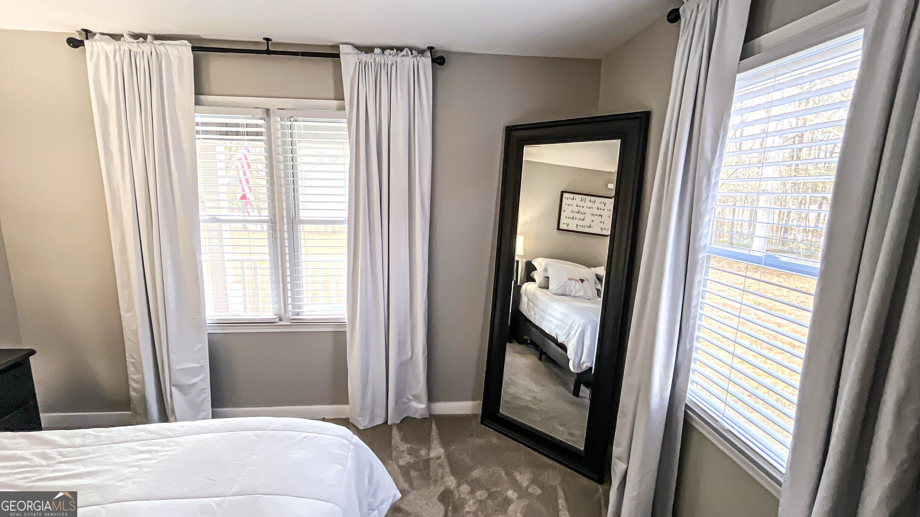 587 Highway 41 Milner, GA 30257 - Photo 49 of 172 a bedroom with a bed and a window with a mirror