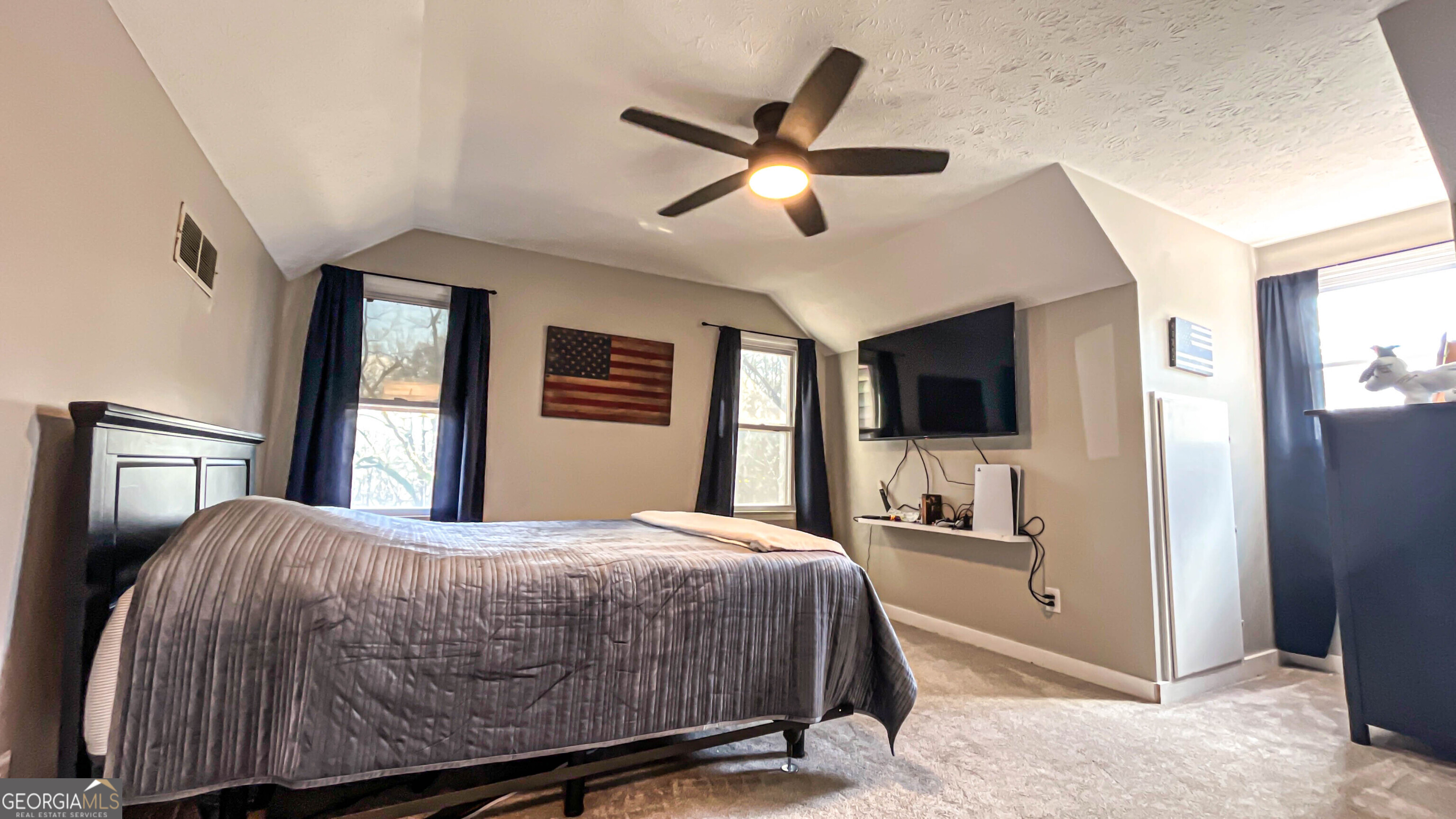 587 Highway 41 Milner, GA 30257 - Photo 66 of 172 a bedroom with a bed and a large mirror with a flat tv screen