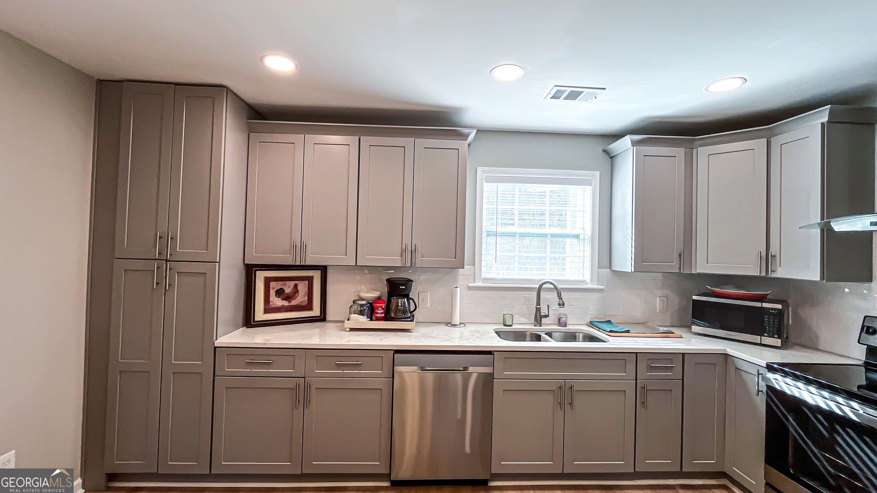 587 Highway 41 Milner, GA 30257 - Photo 81 of 172 a kitchen with stainless steel appliances granite countertop a sink a stove a refrigerator cabinets and a window