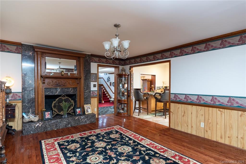 6013 Laney Rogers Road Monroe, NC 28112 - Photo 11 of 43 a room with lots of wooden furniture and a fireplace