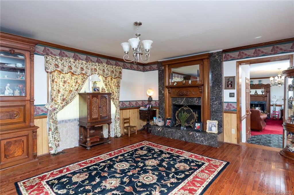 6013 Laney Rogers Road Monroe, NC 28112 - Photo 12 of 43 a living room with fireplace furniture and a chandelier