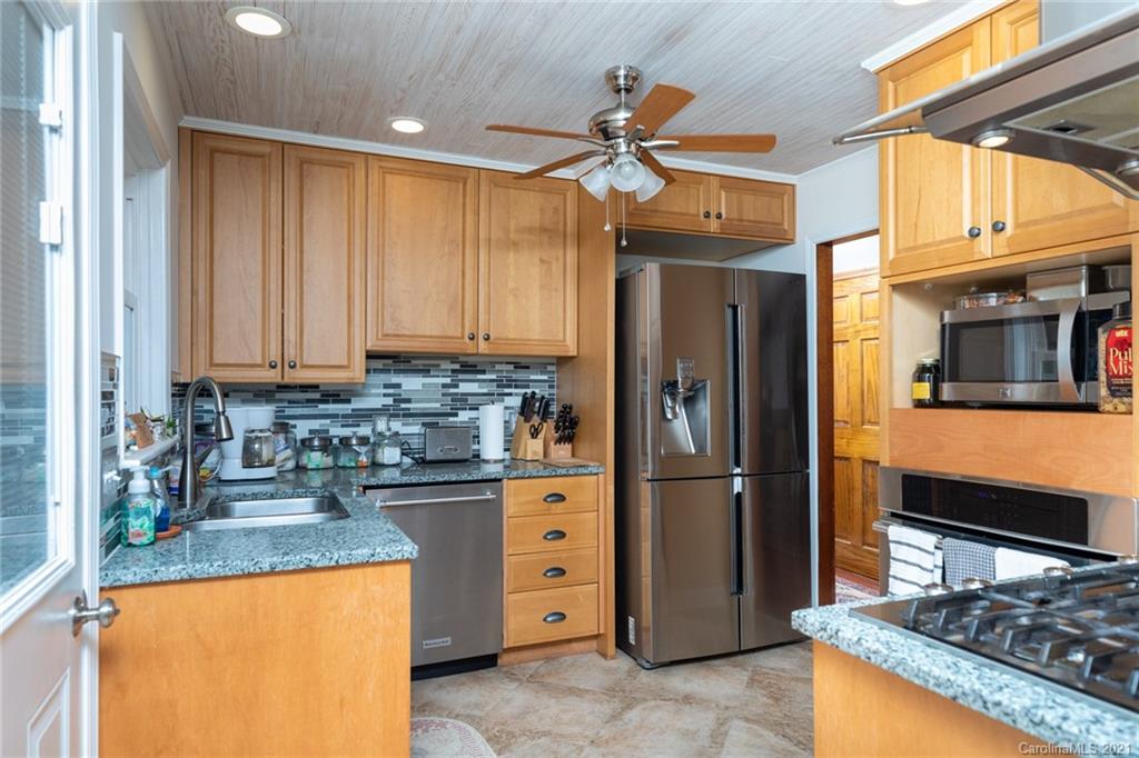 6013 Laney Rogers Road Monroe, NC 28112 - Photo 17 of 43 a kitchen with stainless steel appliances granite countertop a refrigerator a stove and a sink