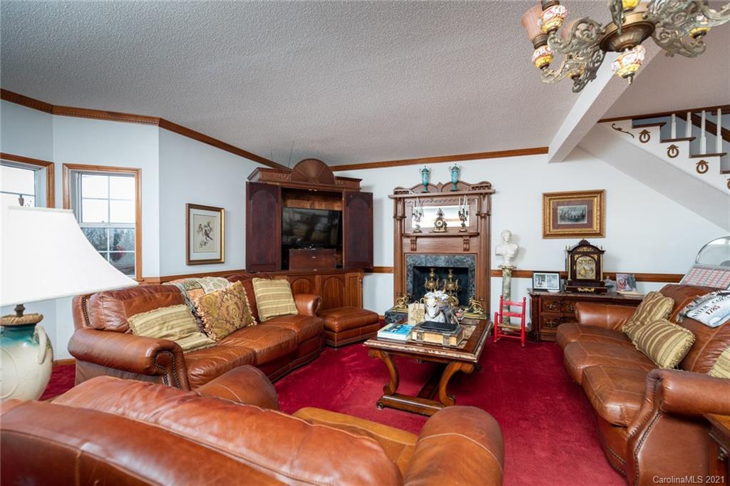 6013 Laney Rogers Road Monroe, NC 28112 - Photo 20 of 43 a living room with furniture chandelier and a fireplace