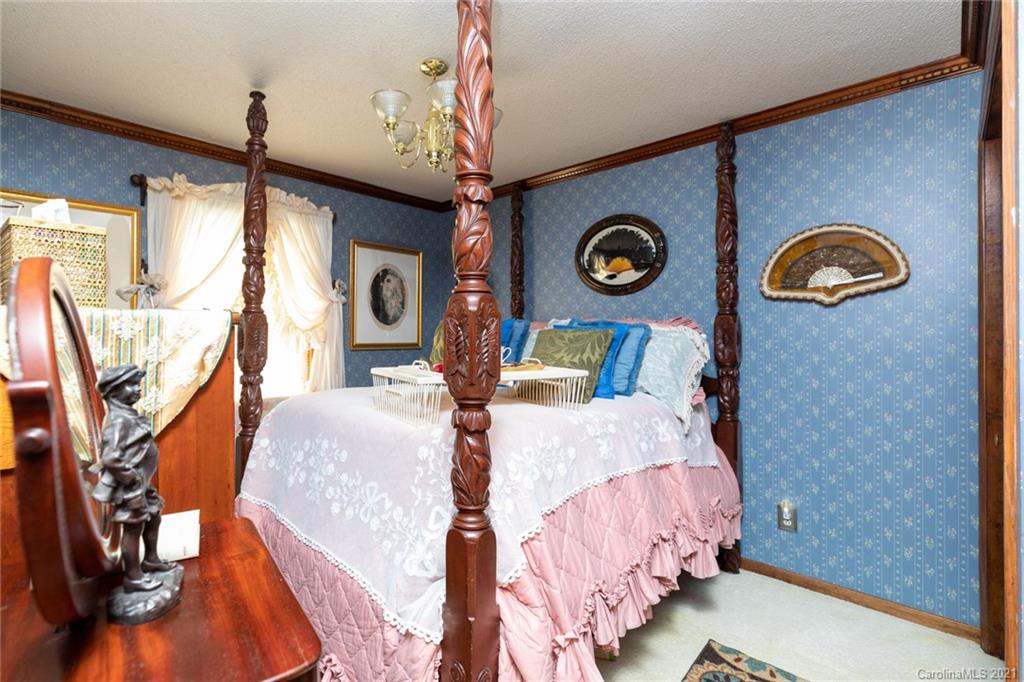 6013 Laney Rogers Road Monroe, NC 28112 - Photo 24 of 43 a bedroom with bed and a chandelier