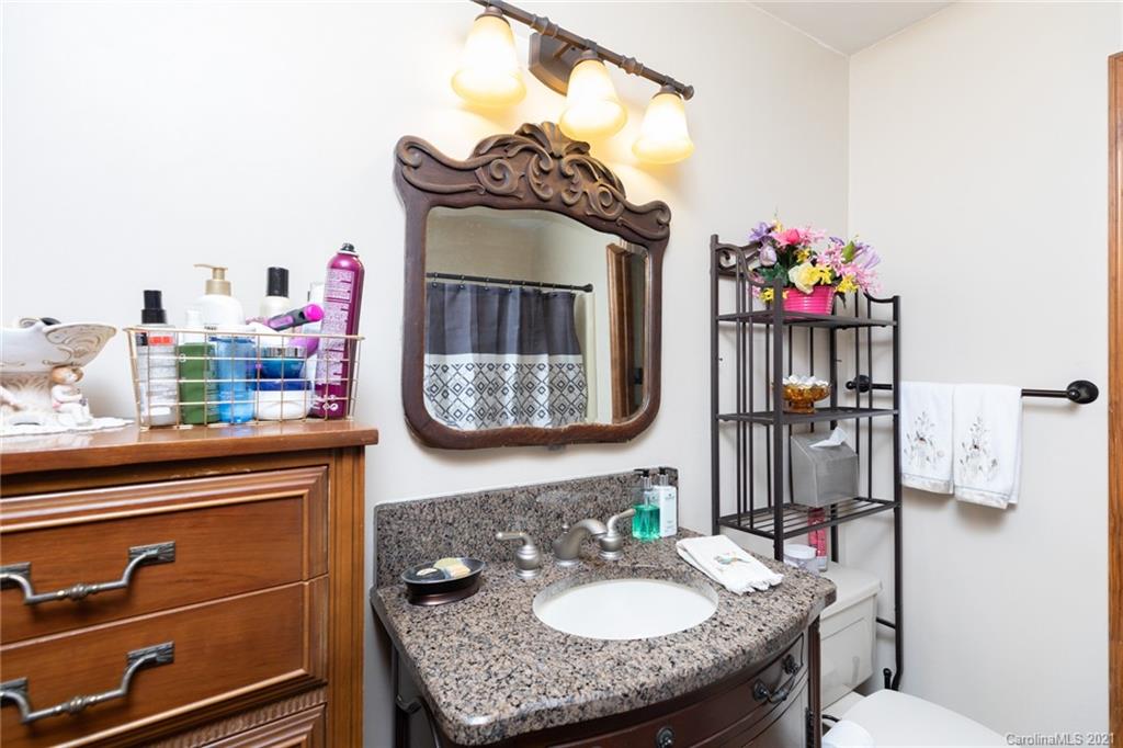 6013 Laney Rogers Road Monroe, NC 28112 - Photo 26 of 43 a bathroom with a sink mirror and vanity