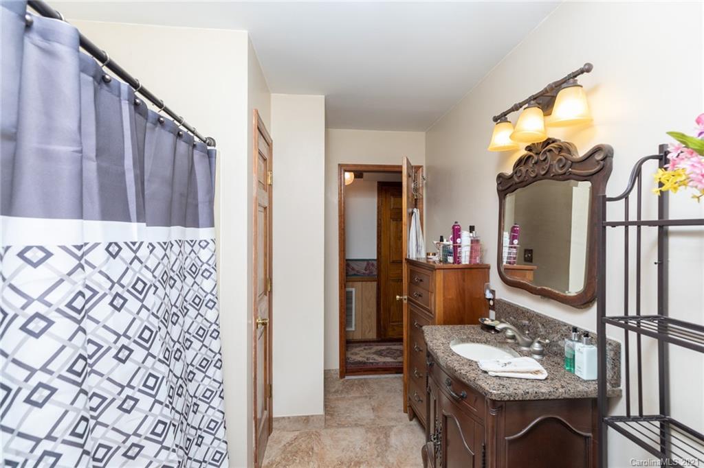 6013 Laney Rogers Road Monroe, NC 28112 - Photo 27 of 43 a bathroom with a sink a mirror and a shower