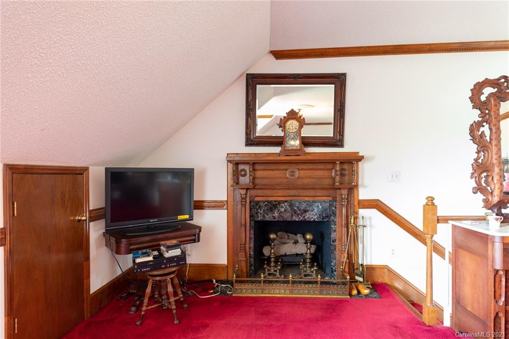 6013 Laney Rogers Road Monroe, NC 28112 - Photo 35 of 43 a living room with furniture a flat screen tv and a fireplace