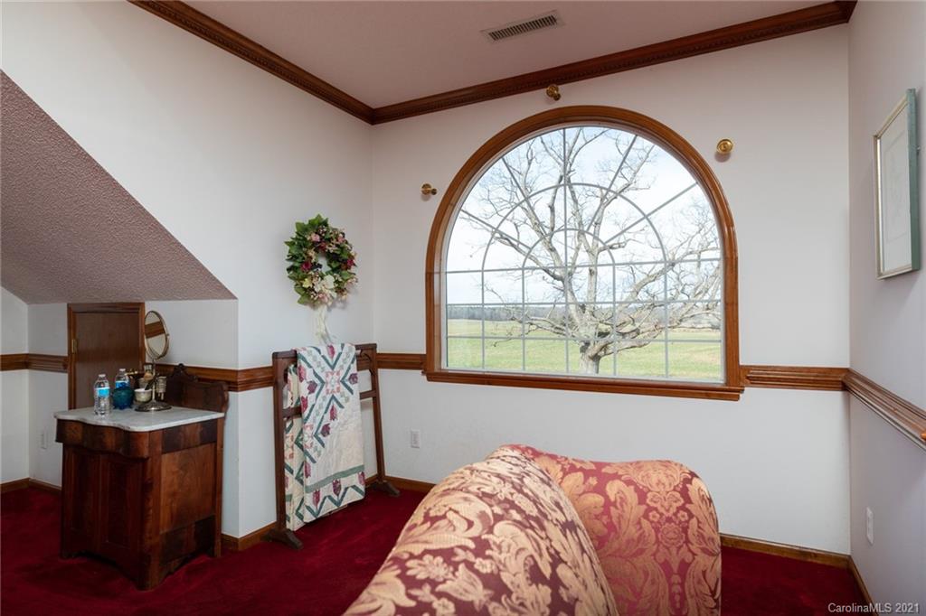 6013 Laney Rogers Road Monroe, NC 28112 - Photo 36 of 43 a bedroom with a bed and a large window
