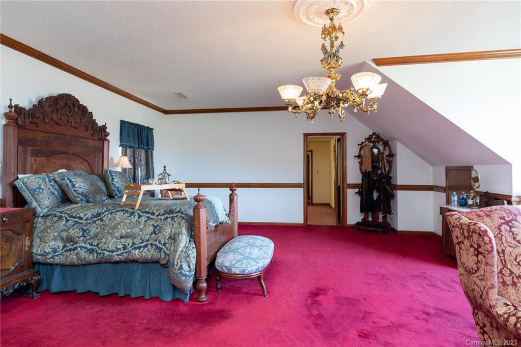 6013 Laney Rogers Road Monroe, NC 28112 - Photo 37 of 43 a living room with furniture and a chandelier