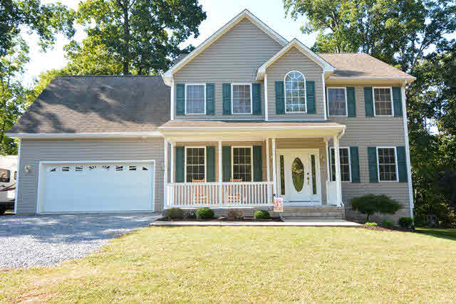 259 Patterson Mill Road Grottoes, VA 24441 - Photo 1 of 26 a front view of a house with a yard and garage