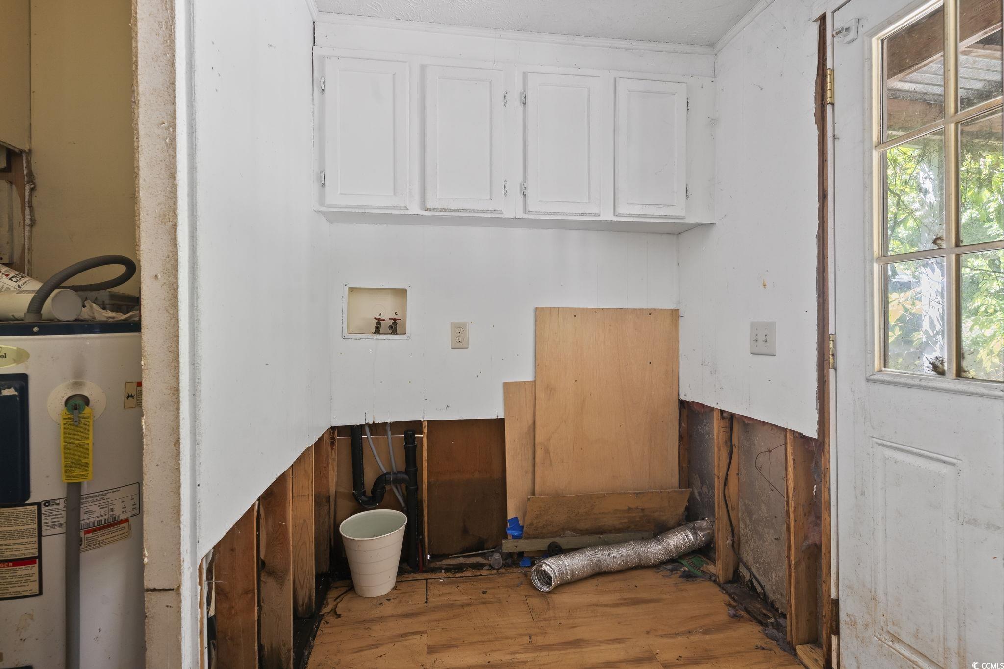 718 Reef Road Myrtle Beach, SC 29588 - Photo 11 of 20 Clothes washing area with cabinet space, wood fini