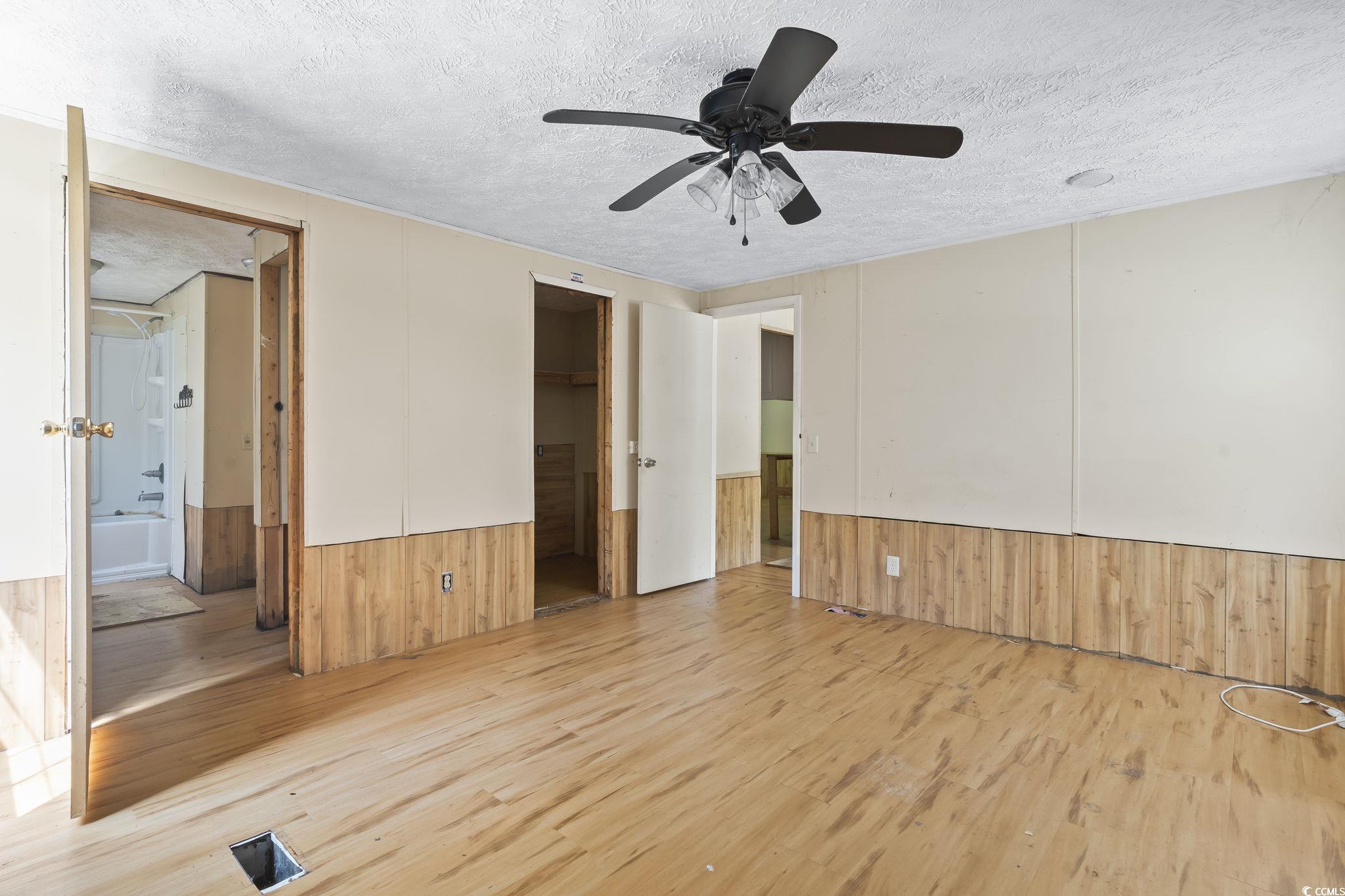 718 Reef Road Myrtle Beach, SC 29588 - Photo 13 of 20 Empty room featuring a textured ceiling, wood fini