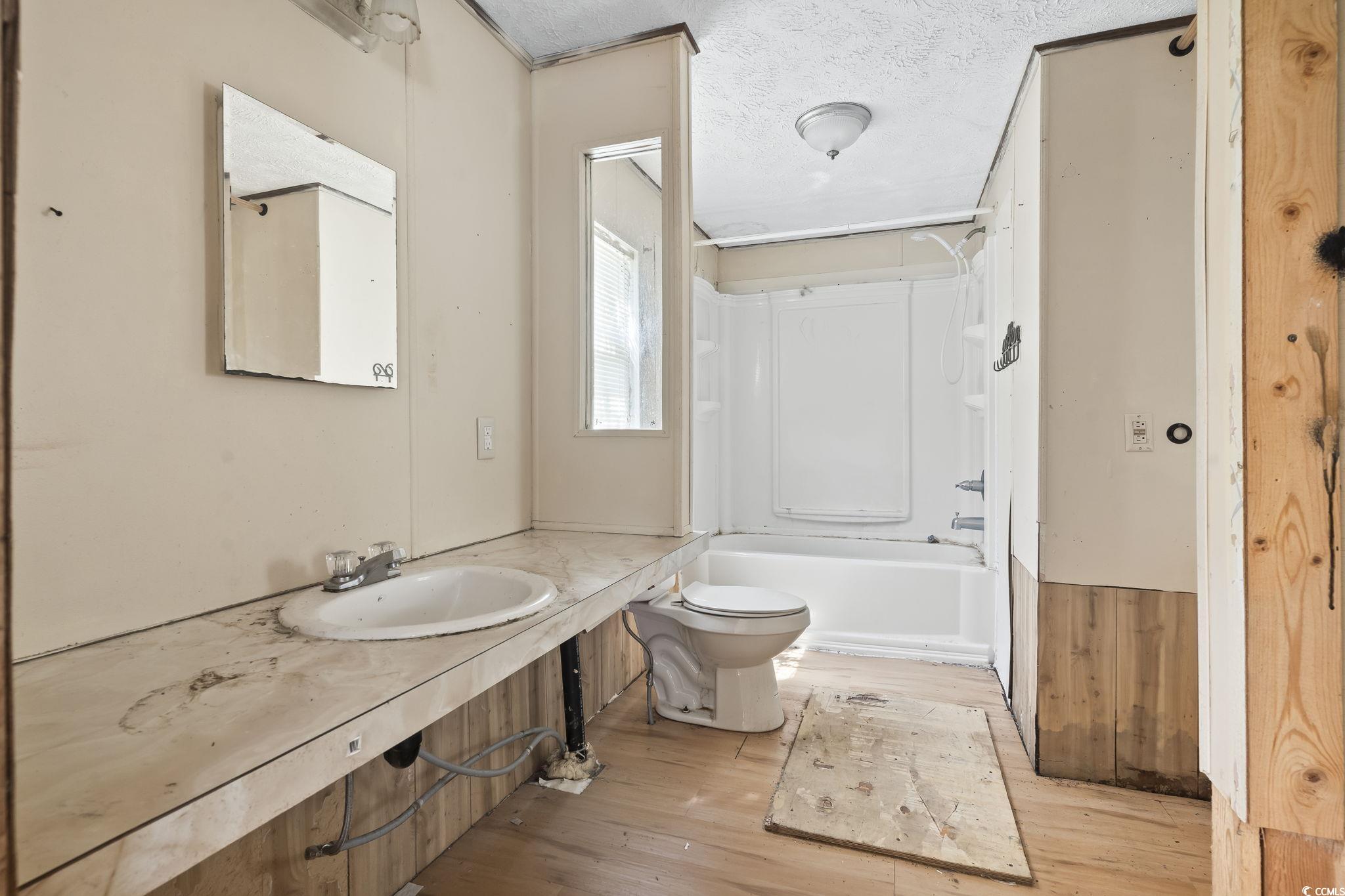 718 Reef Road Myrtle Beach, SC 29588 - Photo 14 of 20 Full bath with vanity, toilet, a textured ceiling,
