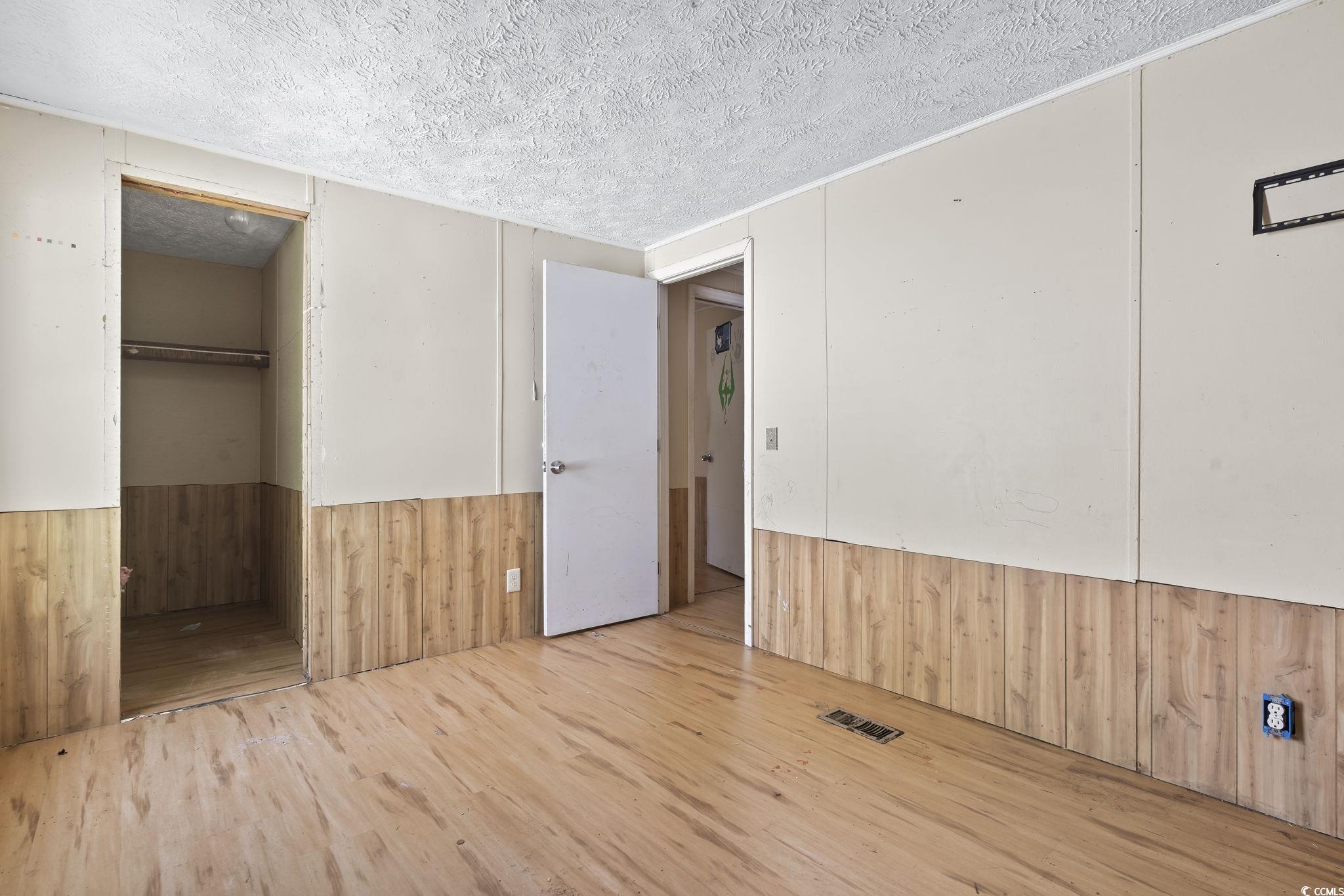 718 Reef Road Myrtle Beach, SC 29588 - Photo 17 of 20 Unfurnished bedroom featuring a textured ceiling,
