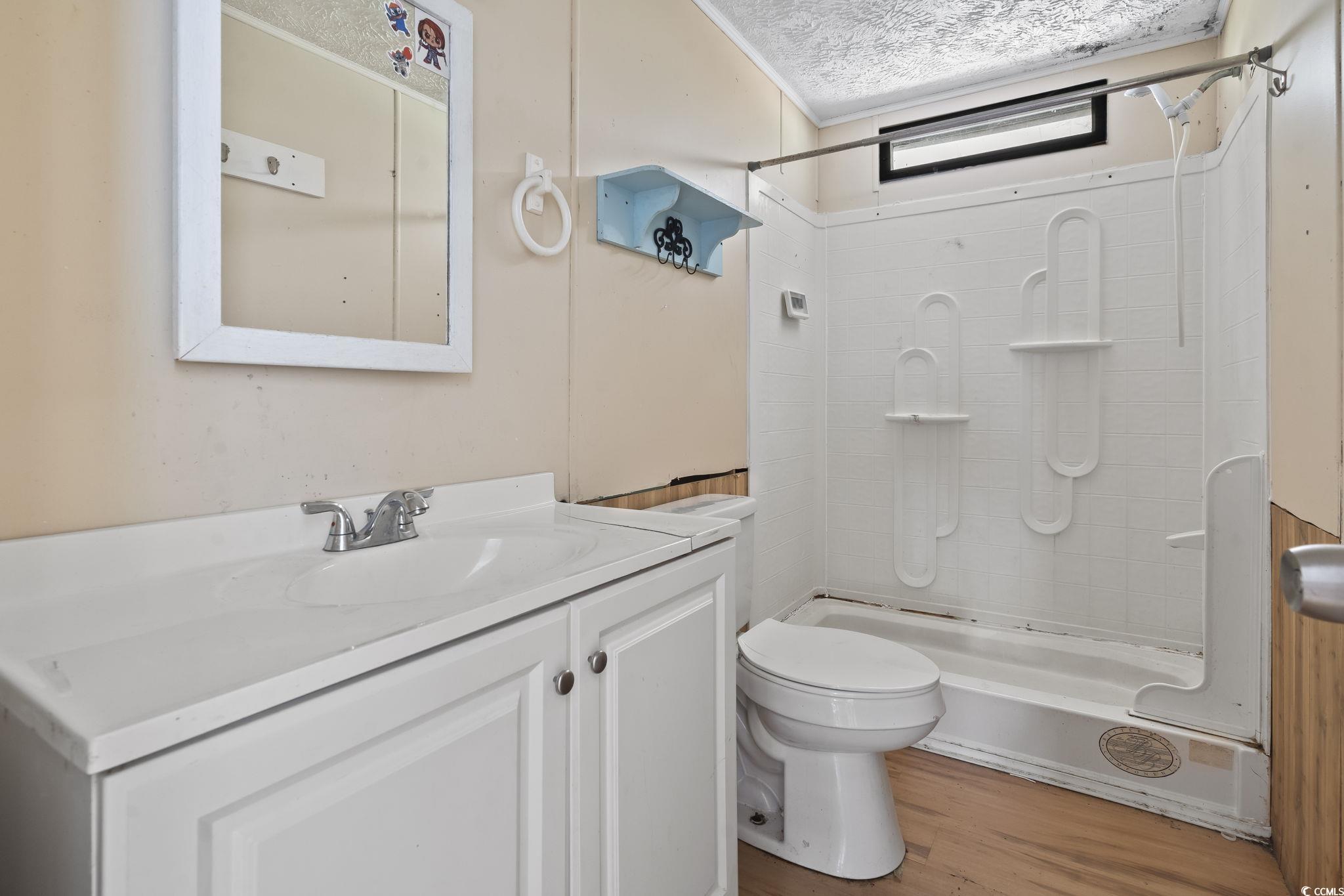 718 Reef Road Myrtle Beach, SC 29588 - Photo 19 of 20 Bathroom with a textured ceiling, walk in shower,