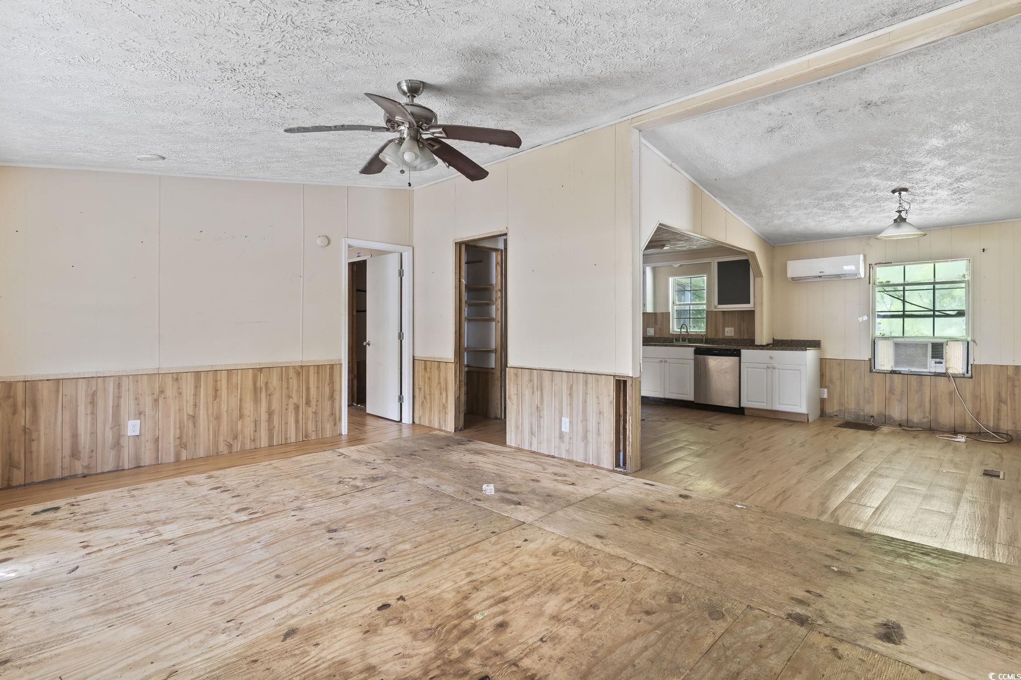 718 Reef Road Myrtle Beach, SC 29588 - Photo 4 of 20 Unfurnished living room featuring wooden walls, ha