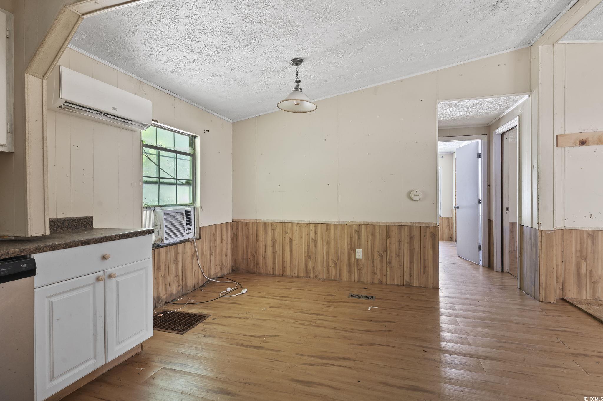 718 Reef Road Myrtle Beach, SC 29588 - Photo 10 of 20 Unfurnished dining area with a textured ceiling, a