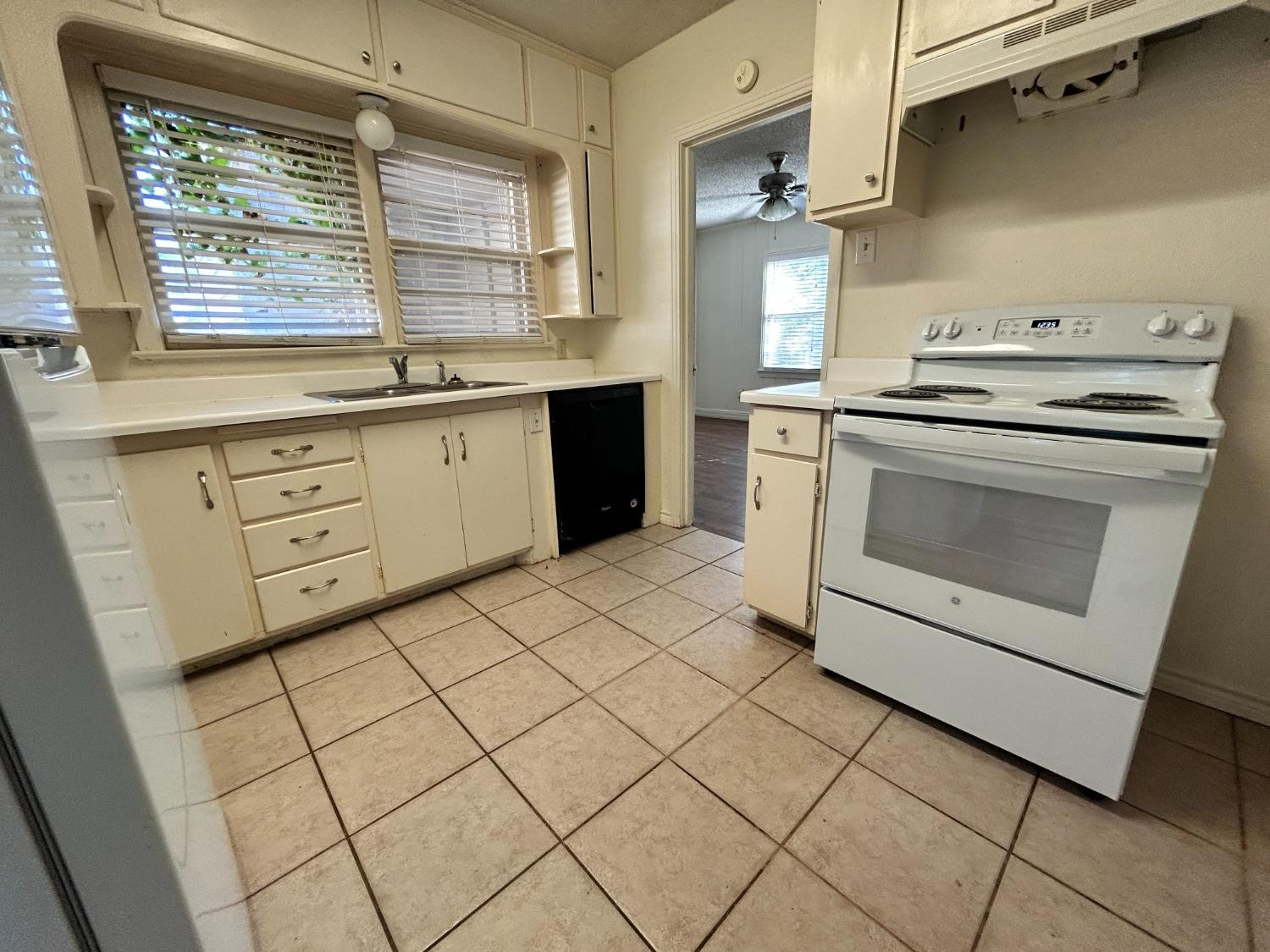2216 30th Street, Unit FRONT Lubbock, TX 79411 - Photo 8 of 11 a kitchen with a stove cabinets and wooden floor