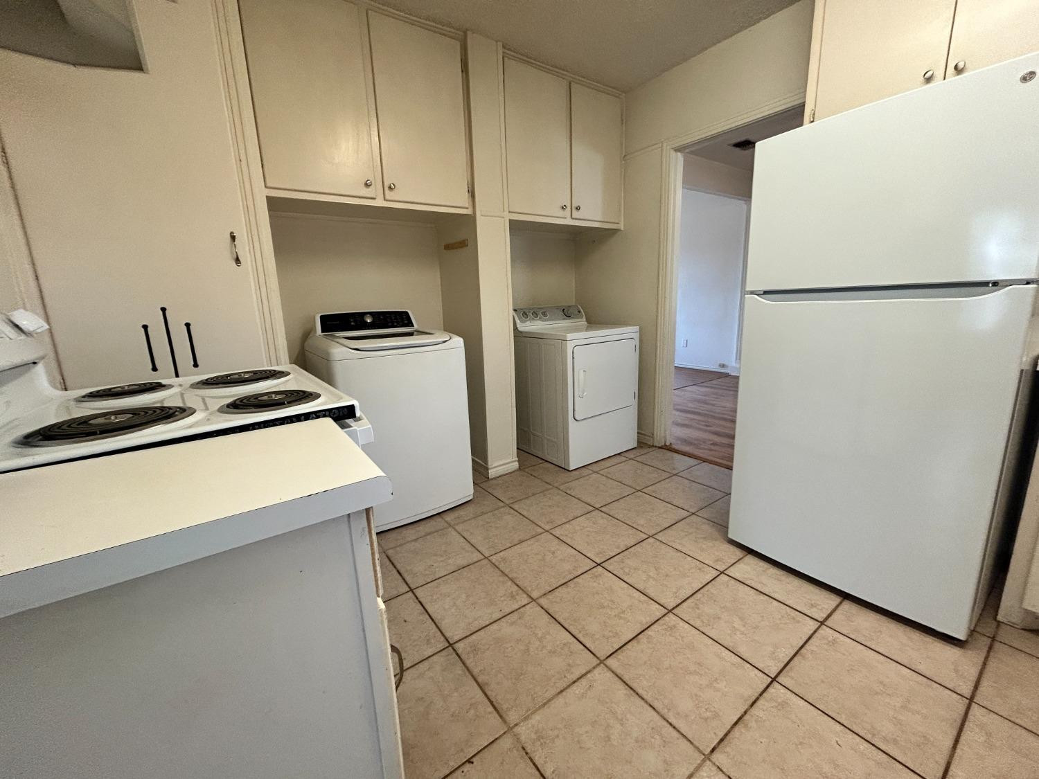 2216 30th Street, Unit FRONT Lubbock, TX 79411 - Photo 9 of 11 a kitchen with a refrigerator sink stove and cabinets