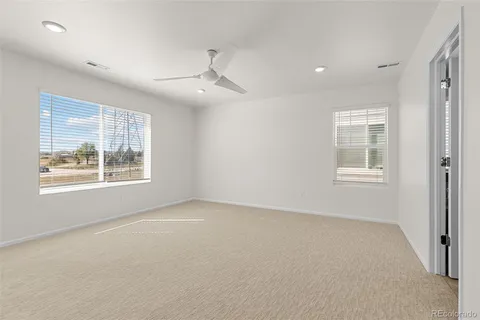 an empty room with a empty space and windows