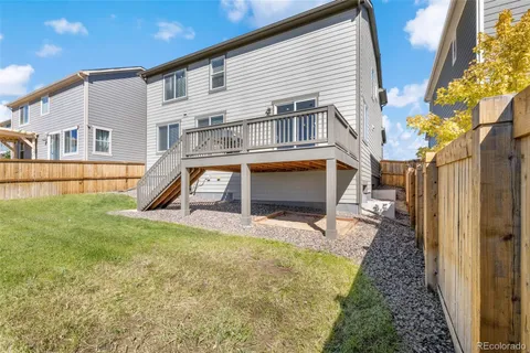 a view of hallway with wooden floor and a dining room