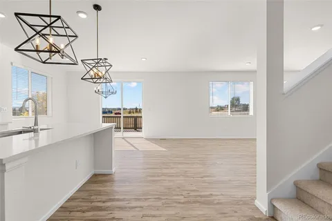 a view of a kitchen with a sink and wooden floor