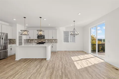 a kitchen with stainless steel appliances granite countertop a refrigerator and a stove top oven