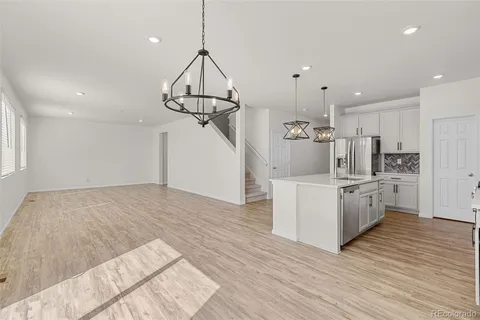 a kitchen with white cabinets and appliances