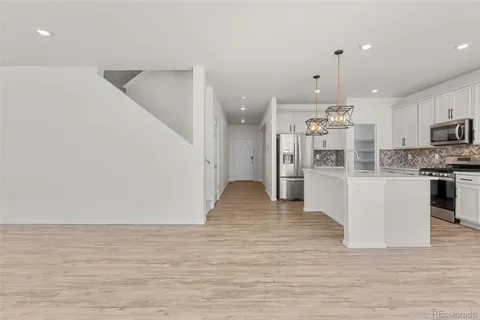 a view of kitchen with wooden floor