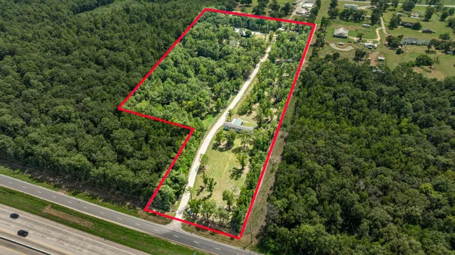 a front view of house with yard and trees