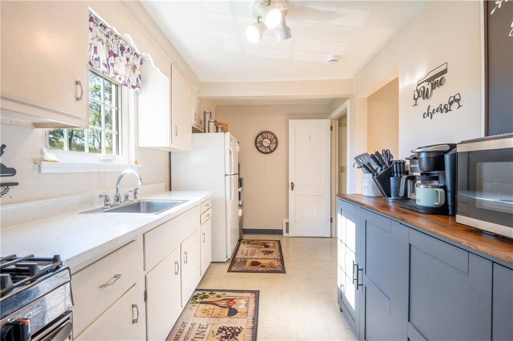 290 Barclay Avenue Pittsburgh, PA 15221 - Photo 11 of 29 a kitchen with granite countertop a sink stove and cabinets