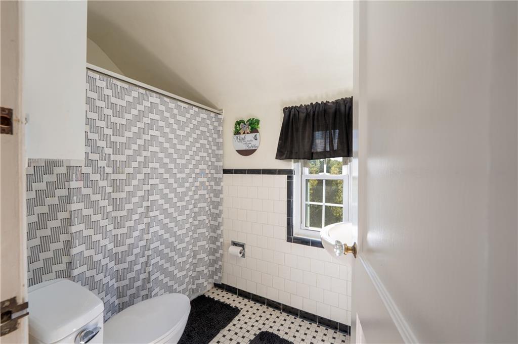 290 Barclay Avenue Pittsburgh, PA 15221 - Photo 19 of 29 a bathroom with a toilet and a shower curtain
