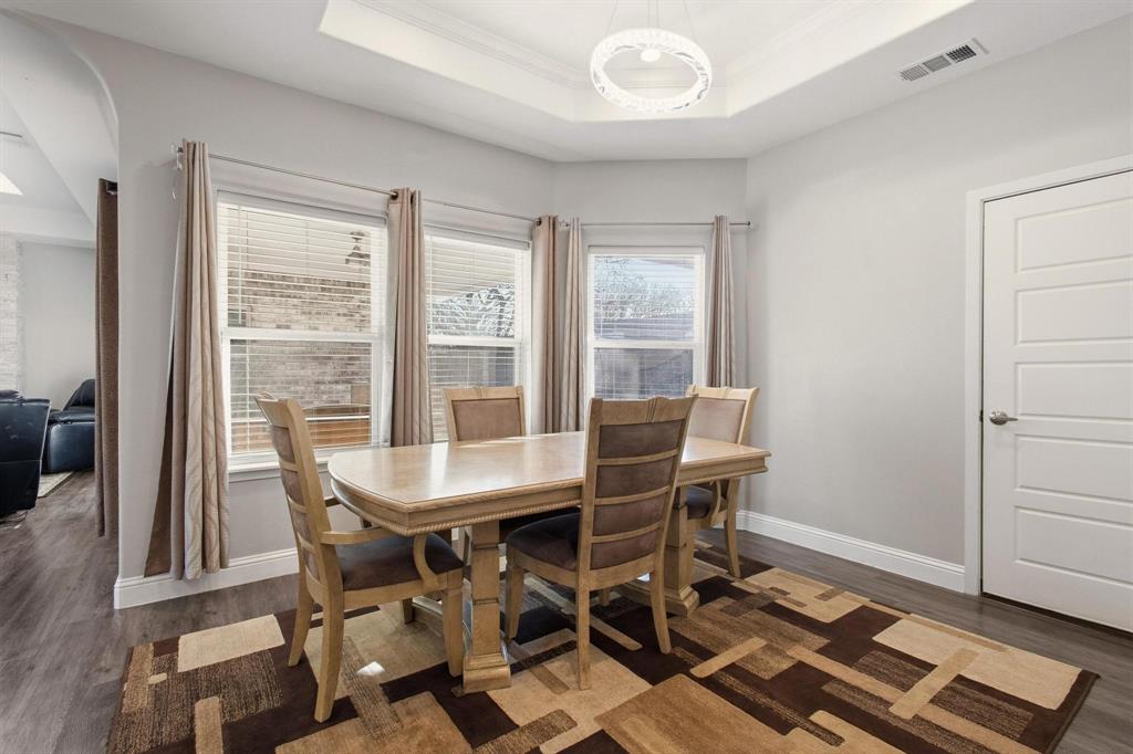 104 4th Street Trenton, TX 75490 - Photo 11 of 33 a view of a dining room with furniture and wooden floor