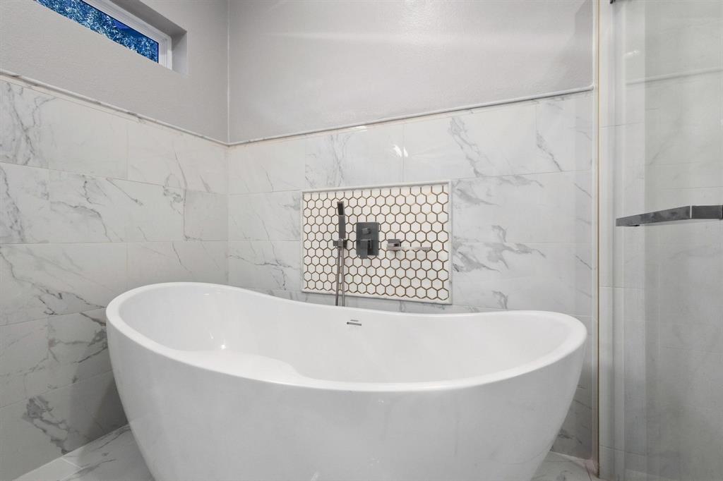 104 4th Street Trenton, TX 75490 - Photo 16 of 33 a white bath tub sitting in a bathroom