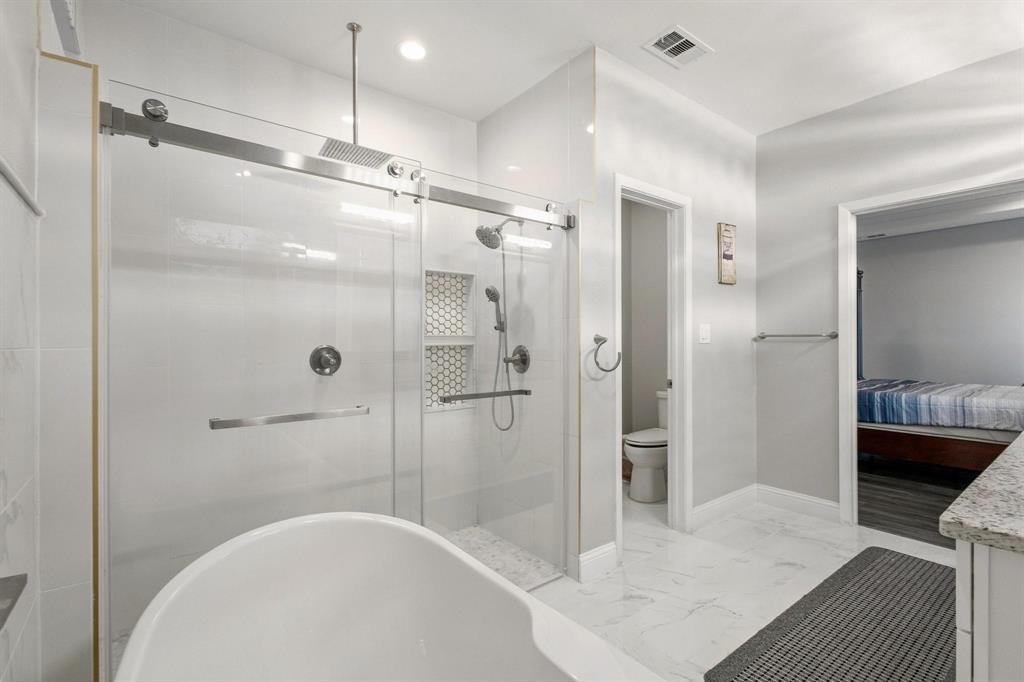 104 4th Street Trenton, TX 75490 - Photo 17 of 33 a bathroom with a shower and a tub