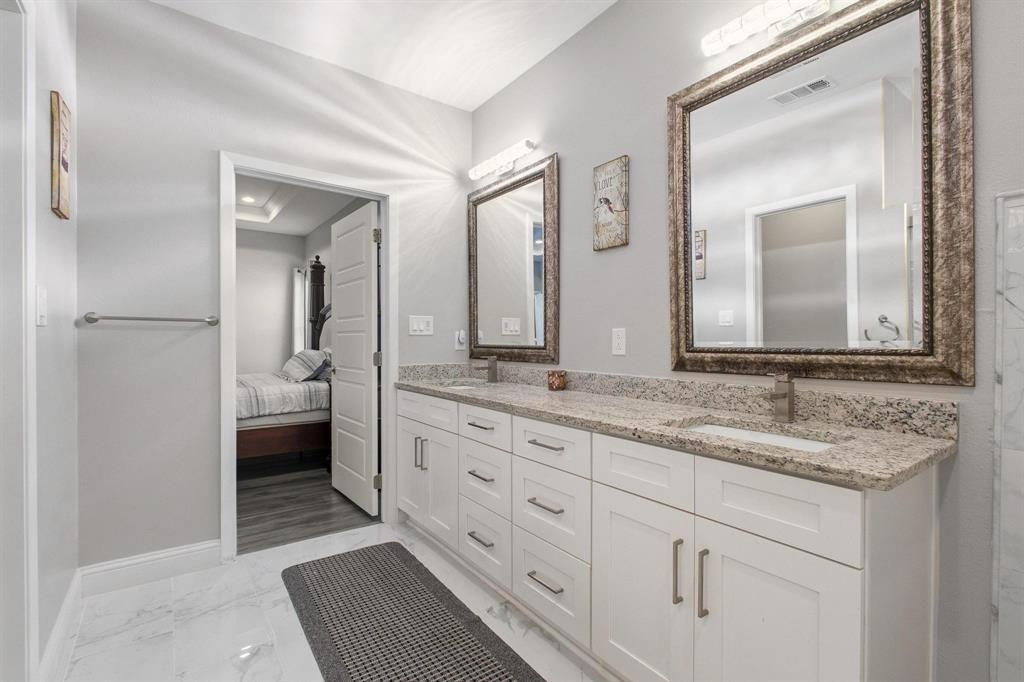 104 4th Street Trenton, TX 75490 - Photo 18 of 33 a en suite bathroom with a granite countertop sink and a mirror
