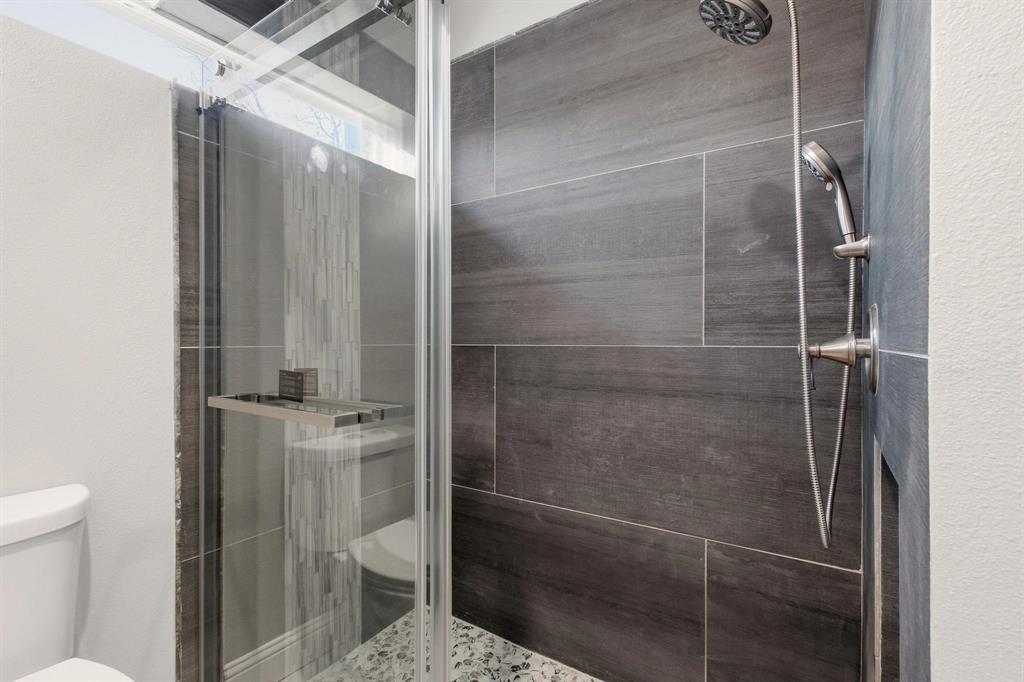 104 4th Street Trenton, TX 75490 - Photo 22 of 33 a bathroom with a toilet and a shower