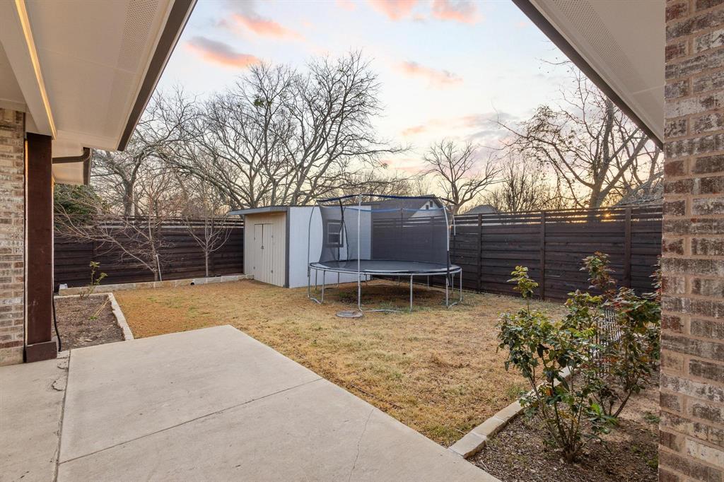 104 4th Street Trenton, TX 75490 - Photo 29 of 33 a backyard of a house with table and chairs