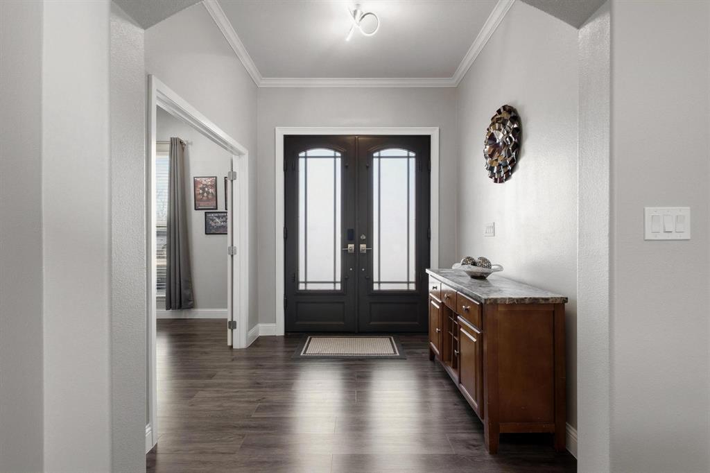 104 4th Street Trenton, TX 75490 - Photo 4 of 33 wooden floor with a window in a hall with an entryway