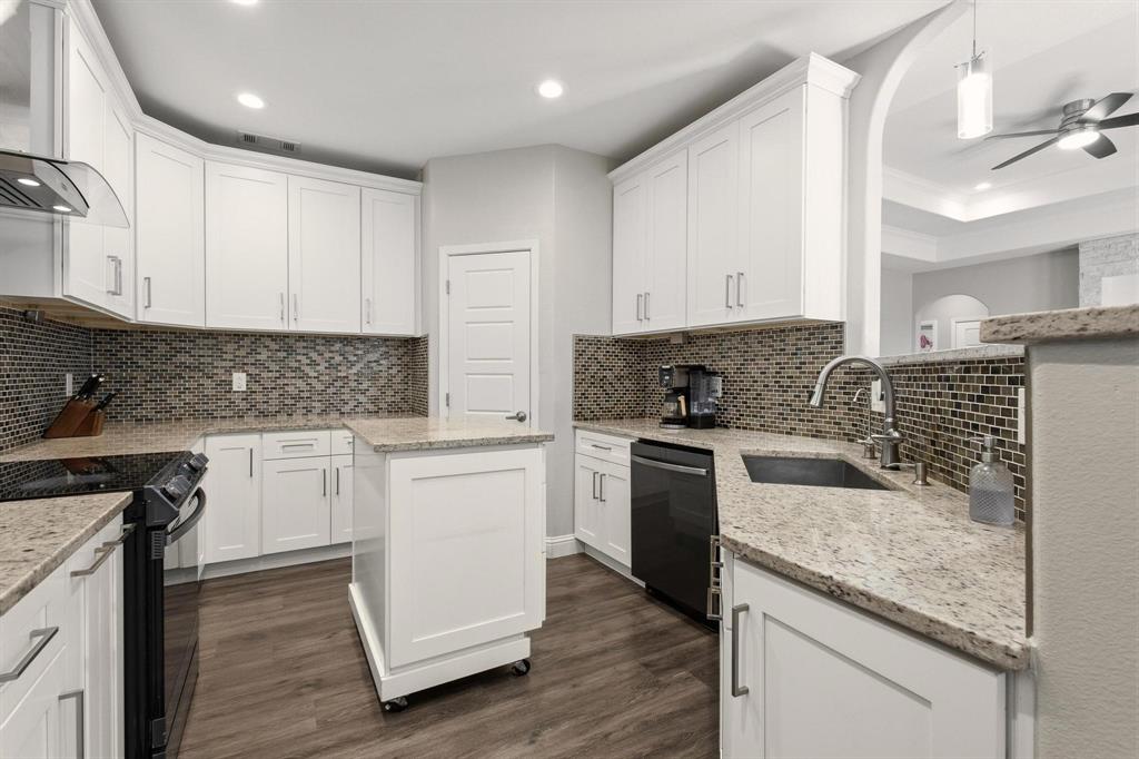 104 4th Street Trenton, TX 75490 - Photo 8 of 33 a kitchen with granite countertop white cabinets and white appliances