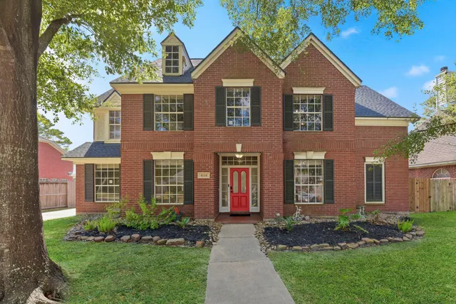 front view of brick house with a yard