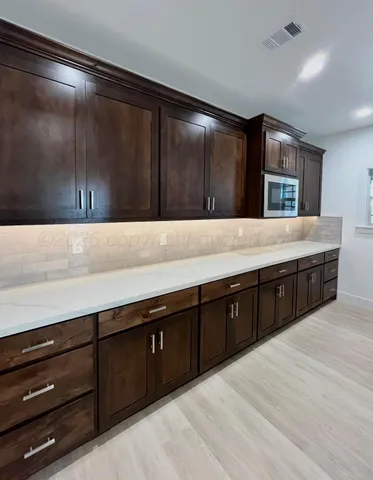 a living room with wooden cabinets