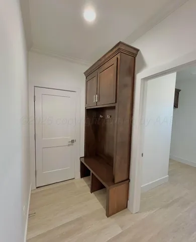 a room with a walk in closet and wooden floor