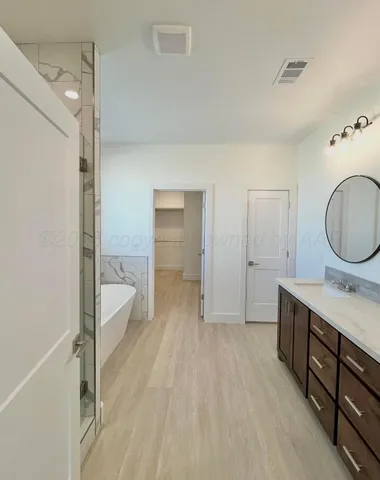 a bathroom with a sink mirror vanity and toilet