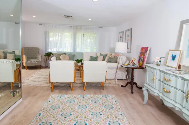 a view of a workspace with furniture and a living room