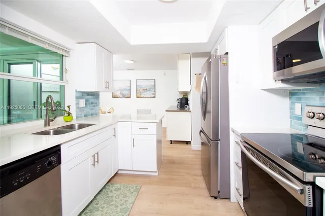 a kitchen with a sink stove and refrigerator