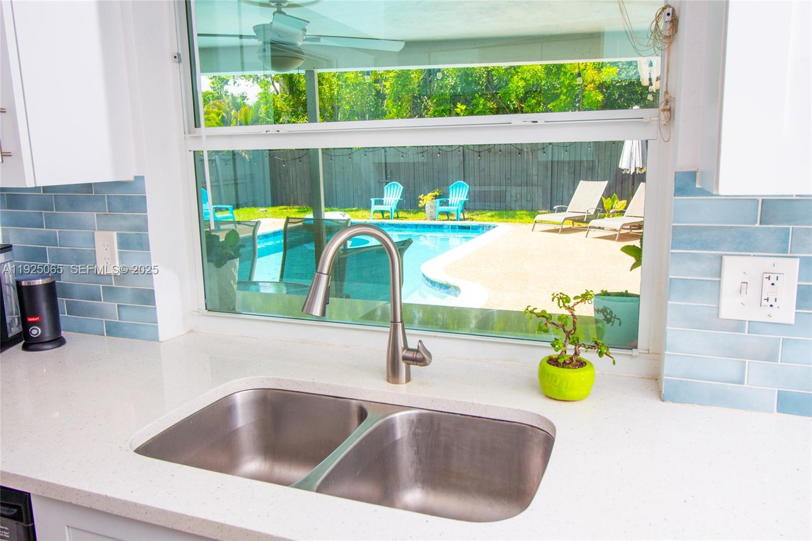 107 Winged Foot Lane Boca Raton, FL 33431 - Photo 19 of 46 a kitchen sink with a stove