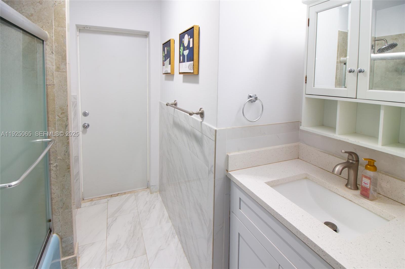 107 Winged Foot Lane Boca Raton, FL 33431 - Photo 21 of 46 a bathroom with a sink and mirror