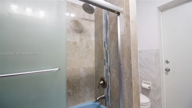 a bathroom with a shower and a mirror