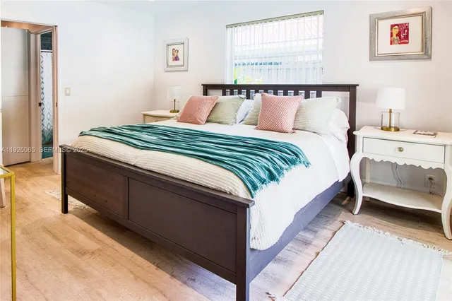 a bedroom with bed and window